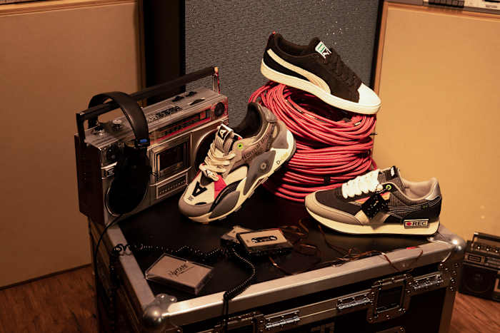 PUMA sneakers propped on a stereo system.